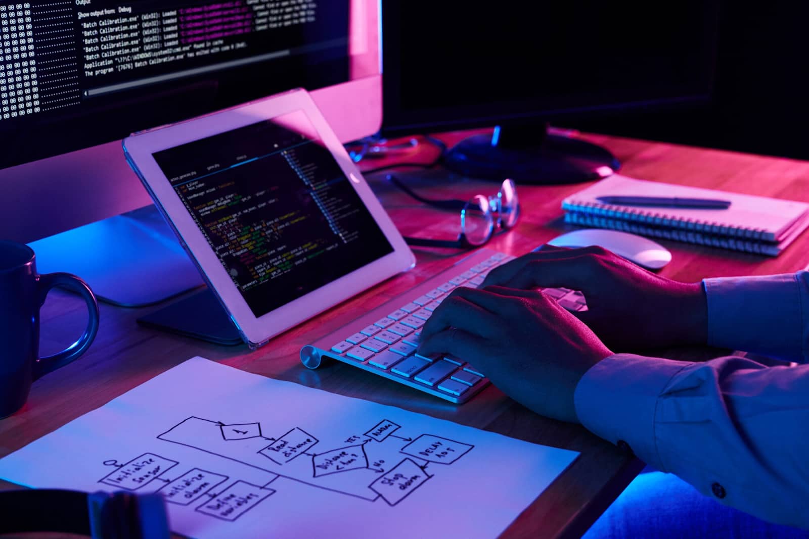 Close-up image of programer working at his desk in office