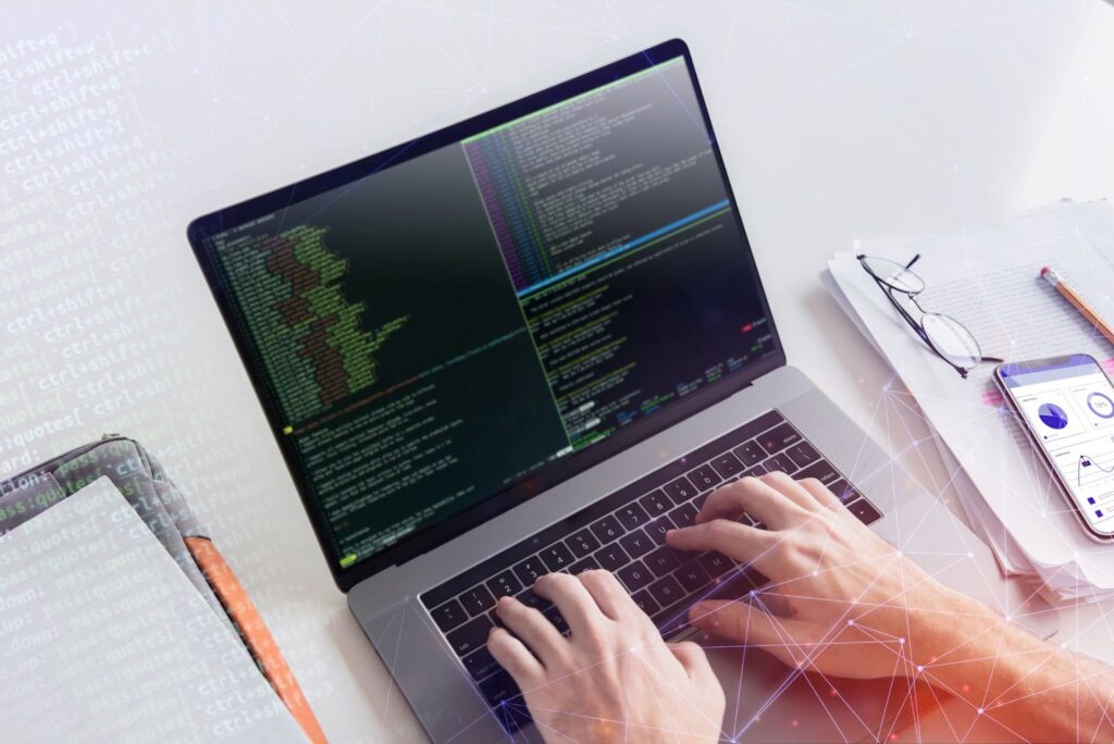 Top view of man working with code on his laptop