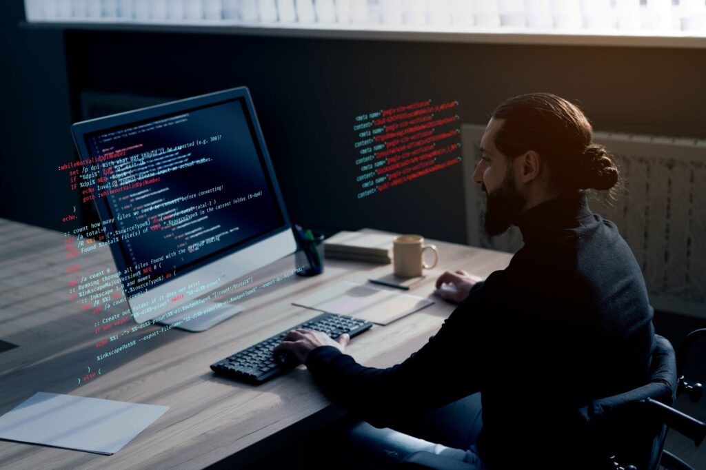 Man working on computer with code