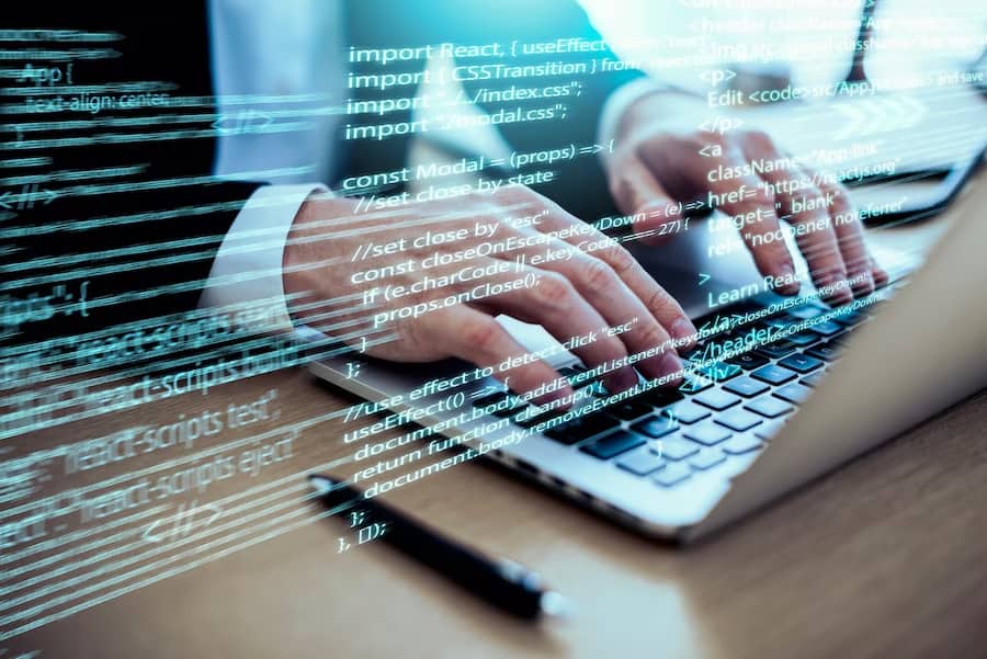 A man is typing computer code