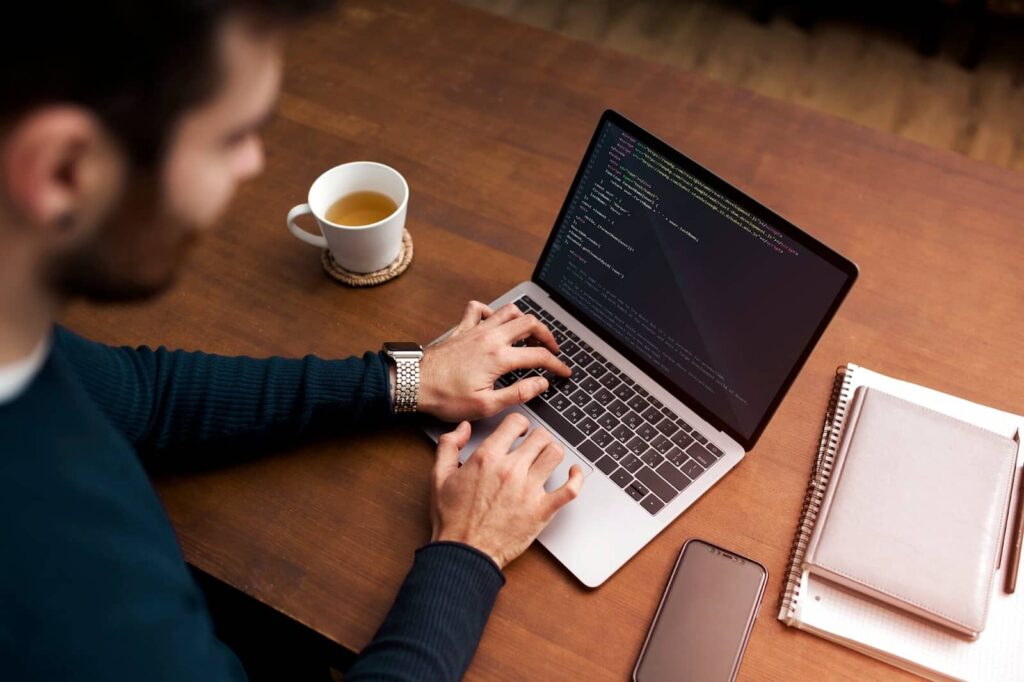 High angle man working on laptop